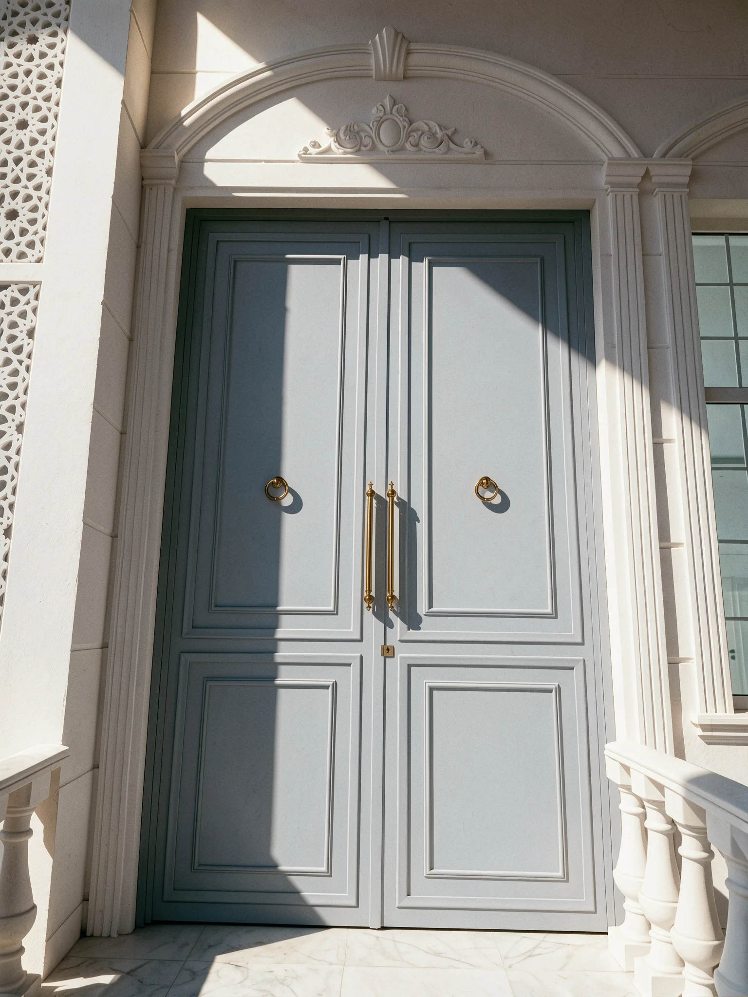 A light ash-grey classical double steel door with brass handles — Front view